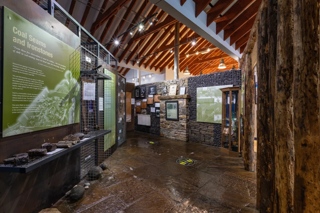 Exhibition space at Arigna Mining Experience featuring displays on coal history, mining tools, and visitor information.